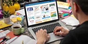 Person studying Amazon FBA course options on laptop.